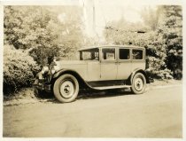 Black and white print of a Packard parked outside