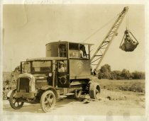 One sepia-toned photograph of a City of Detroit Water Board truck-mounted clamshell bucket excavator