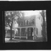 [Group on the porch of a house]