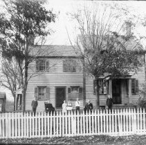 [Family group in front of unidentified house]