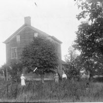 [Farmhouse with people and a dog]