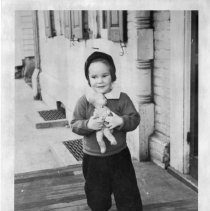 [Girl with doll in front of Bainbridge House]