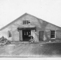[Garage with man and bicycle]