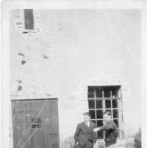 [Men by Stone Building]