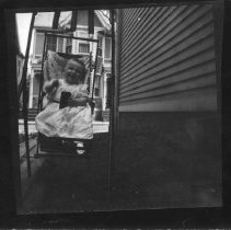 [Baby in Swing on Bank Street]