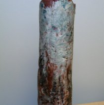 Tall cylinder vase, glazed in blue and dark red tones