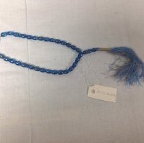 Blue prayer bead strand with blue and gold tassle