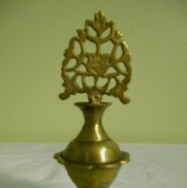 Small bronze cosmetics jar with an hourglass shape and ornate handle on top