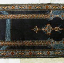 Prayer rug with ornate column design in blue and gold