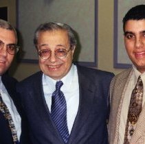 Color photo of three men in suits