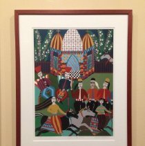 Framed artwork with colorful building and figures on horseback