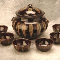 Brown glazed tureen dish and six bowls