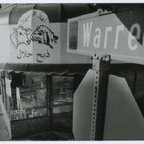 Black and white photo of Warren Ave street sign and butcher's awning