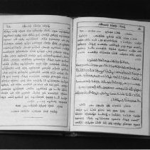 Black and white photo of open prayer book written in Syriac