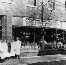 Black & white photo of 5 men standing outside grocery store opening day