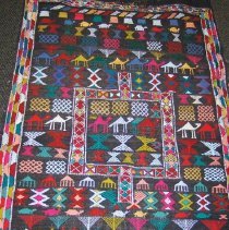 Colorful woven rug with camel and geometric motifs