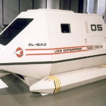 White boxy capsule titled El-Baz Shuttle from Star Trek