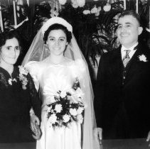 Black & white photo of bride standing with parents