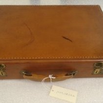 Tan leather briefcase with brass latch locks