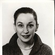 Black and white portrait of woman in dark dotted shirt and pearls