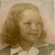 Tinted studio portrait photograph of a young girl in a plaid jumper