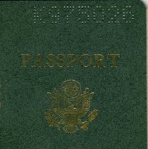 U.S. passport with green cover and punched number canceling its use