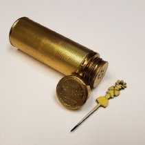 Metalic brass container with plastic wand applicator