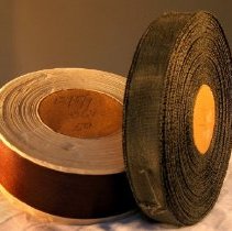 Two rolls or spools of brown ribbon