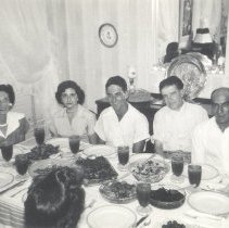1951-01 black and white photo of family sitting down for meal