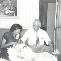 1951-02 black & white photo of man and woman opening presents