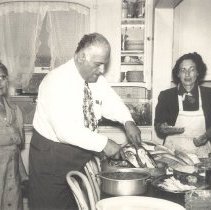 1951-03 black & white photo of man and 2 women in kitchen cooking