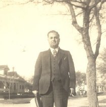 1930-01 sepia tone photo of man standing in a yard