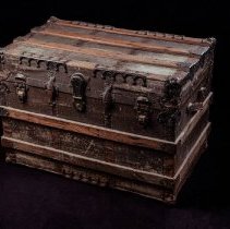Brown wood and metal trunk on black background