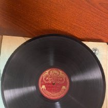 Record with red Macksoud label with gold text and logo