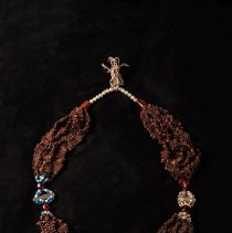 Clove necklace on black background