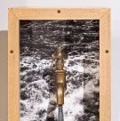 Shadowbox artwork with faucet stopped by a screw