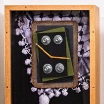 Shadowbox artwork with books, broken pencil and keffiyeh