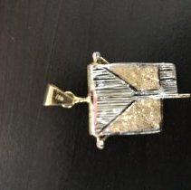 Color photo of gold darfush charm