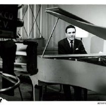 [Pat Ludwig seated at a piano]