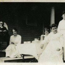 Five People Seated on a Porch
