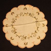White handkerchief with circular vine/white flower pattern and pink border
