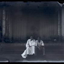 Two  People Seated on a Porch at Lake Waramaug