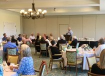 Chairman Roach addresses the audience (with presenters seated to his right)