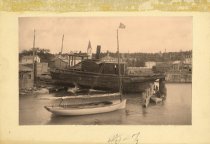 I.S. Feudlater in small boat next to sailboat and larger boat