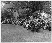 Crowd at Memorial service in Zorn Park, Lena Hills by flag