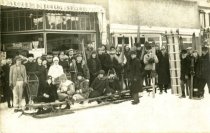 People enjoying winter sports outside Drug Store