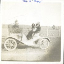Byge and Joe (the dog) in a small automobile.