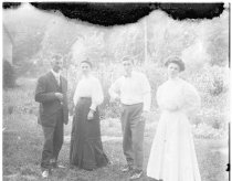 Men and women standing in a garden.