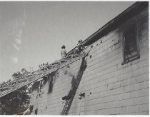 Firefighters on ladder at Old Ice House Fire