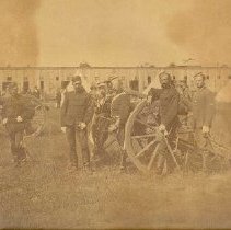 Group of soldiers beside gun carriages in large field, photograph, ca. 1915